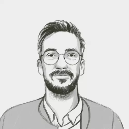 Auf dem gezeichneten schwarz-weiß Bild ist ein Mann mit Brille, kurzen Haaren und Bart zu sehen, der freundlich drein blickt