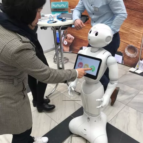 Person lässt den Roboter Pepper tanzen