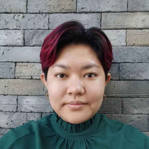 Picture of Aye Min Thant standing in front a brick wall
