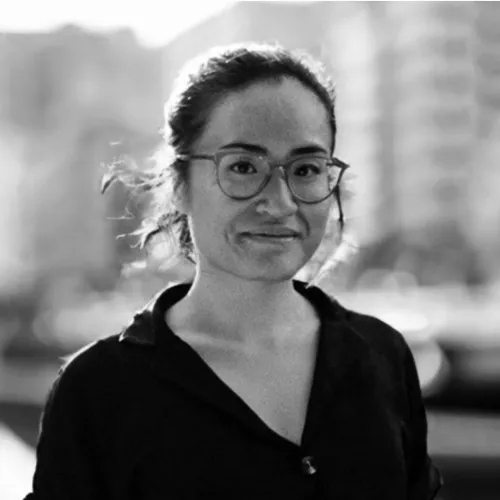 Person with glasses and black hair tied to a ponytail