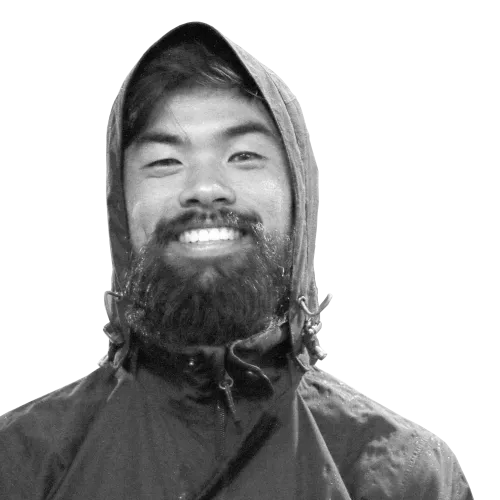 Brazilian individual with Asian features, a long beard, and a raincoat, 